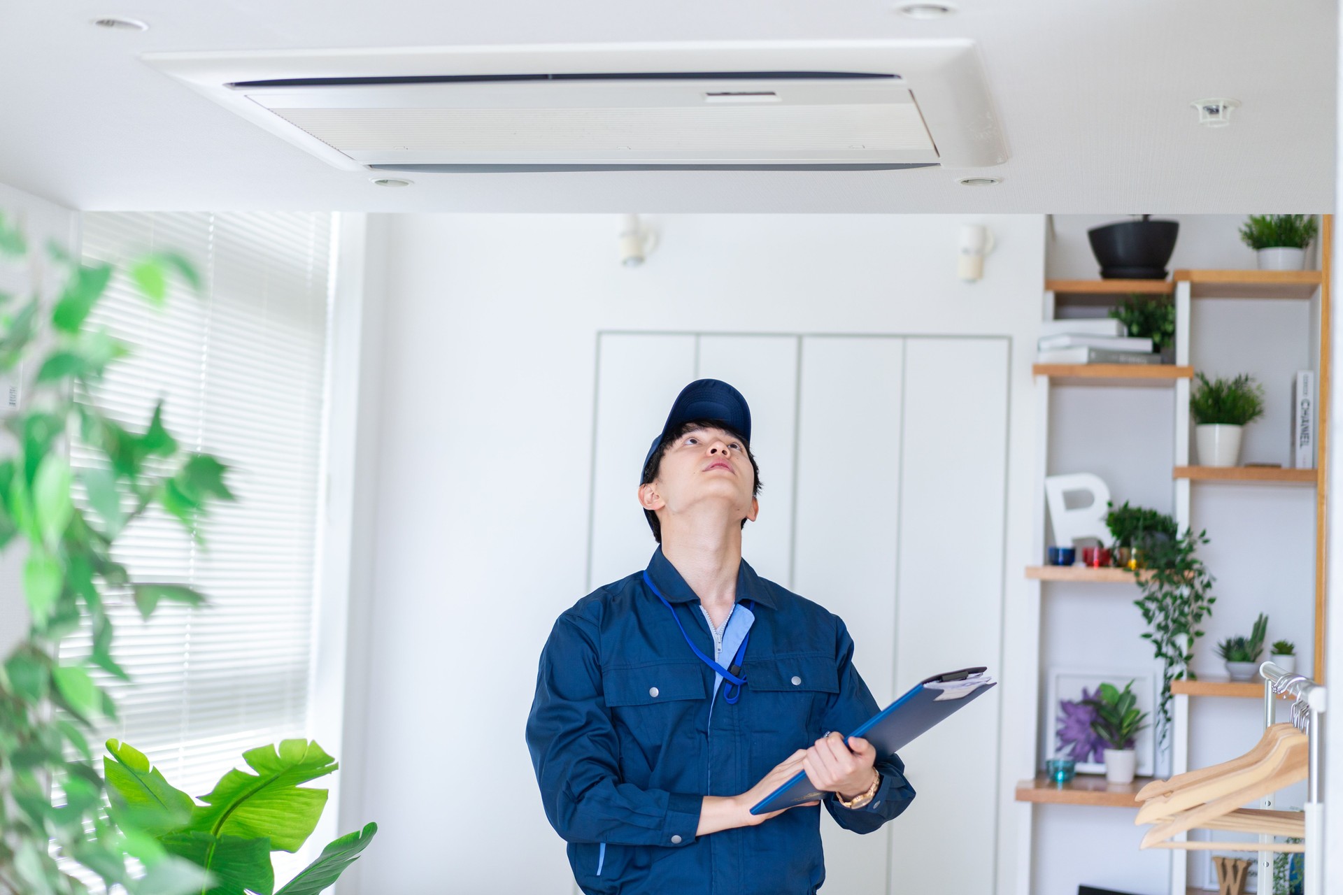 Man in work clothes inspecting a house